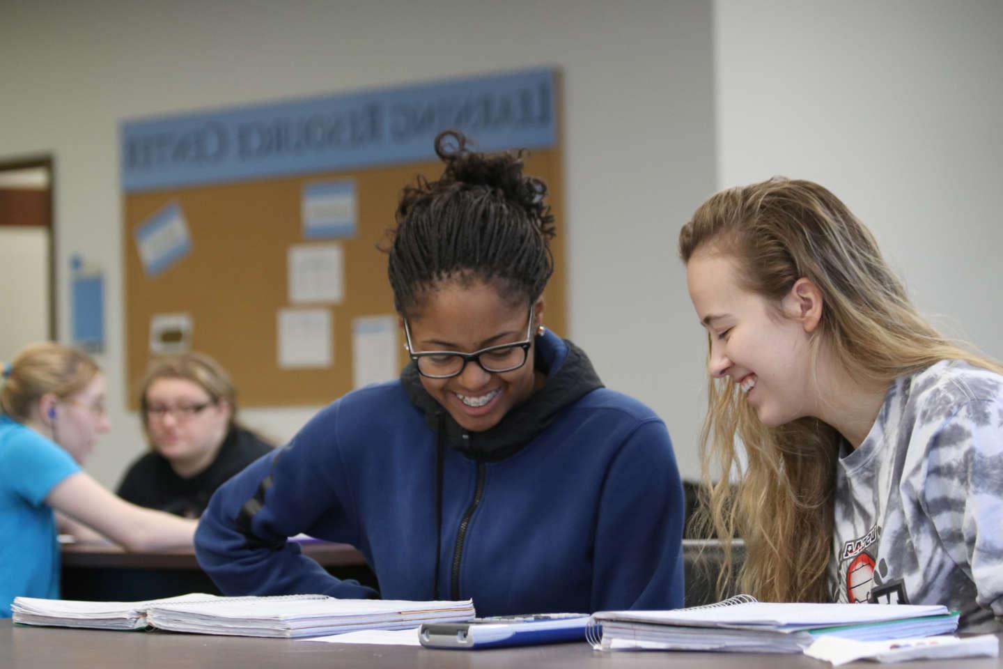 Student mentors helping SMWC students with homework at the LRC