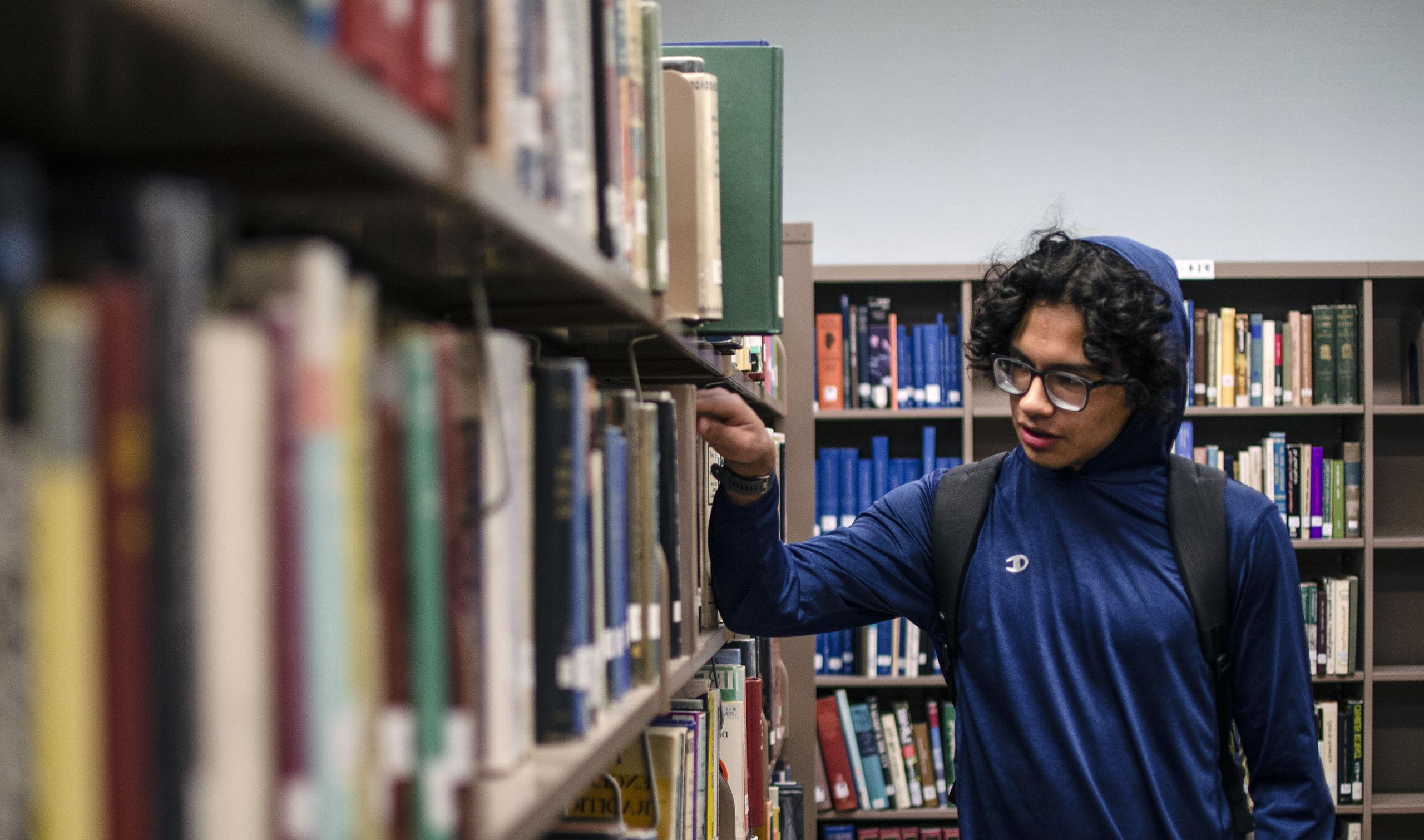 Student browsing books in the library